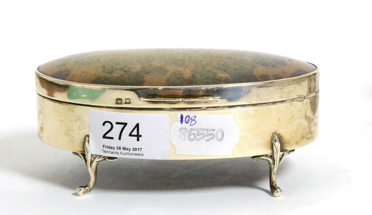 A silver and tortoiseshell mounted oval trinket box, raised on four scroll feet