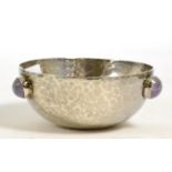 An Arts & Crafts style white metal bowl mounted with three amethyst cabochons, with allover hammer