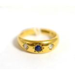 An 18ct gold sapphire and diamond three stone ring