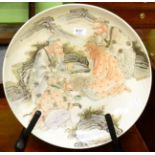 A large Chinese porcelain shallow bowl, depicting four figures in a landscape