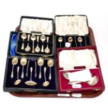 A cased set of six silver coffee bean spoons, a set of six silver teaspoons, a cased set of six