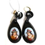 A pair of jet earrings, each set with an oval portrait of a man to oval jet frames with carved