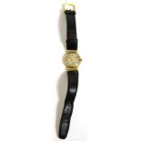 A 9ct gold gents wristwatch with hinged lugs