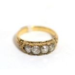 A diamond ring, four graduated old cut diamonds spaced by rose cut diamond accents, in a yellow