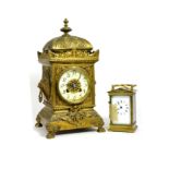 A gilt brass striking mantel clock and a brass carriage timepiece (2)