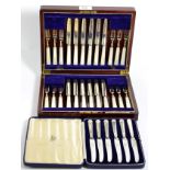 A cased set of silver plated cake knives and forks with mother-of-pearl handles, fitted mahogany