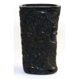 A Chinese carved bovine horn libation cup, carved with figures amongst pine and bamboo, bears four