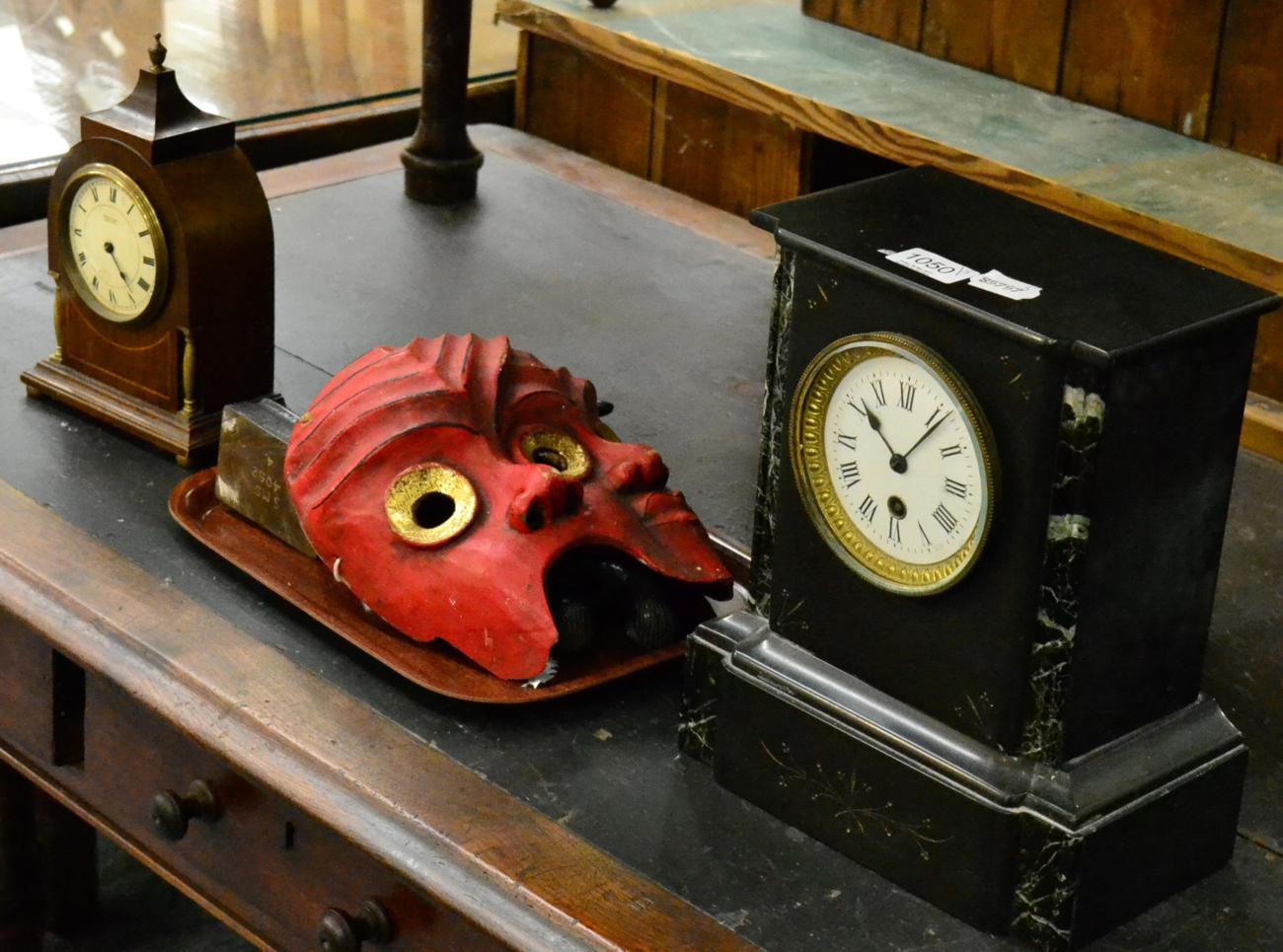 A Victorian black slate mantel timepiece, an Edwardian inlaid mantle timepiece, two tribal