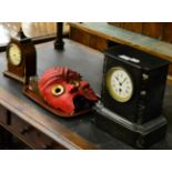 A Victorian black slate mantel timepiece, an Edwardian inlaid mantle timepiece, two tribal