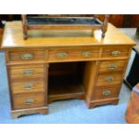 A late Victorian walnut desk, stamped James Shoolbred & Co, 123cm wide