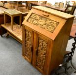 A carved oak bureau, matching side table dated 1944, coffee table and a lamp table (4)