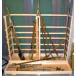 Collection of vintage garden tools in display rack