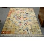 A modernist rug, the field comprised of polychrome squares centred by a naturalistic floral display,