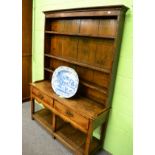 An 18th century oak two drawer dresser with pot board and rack