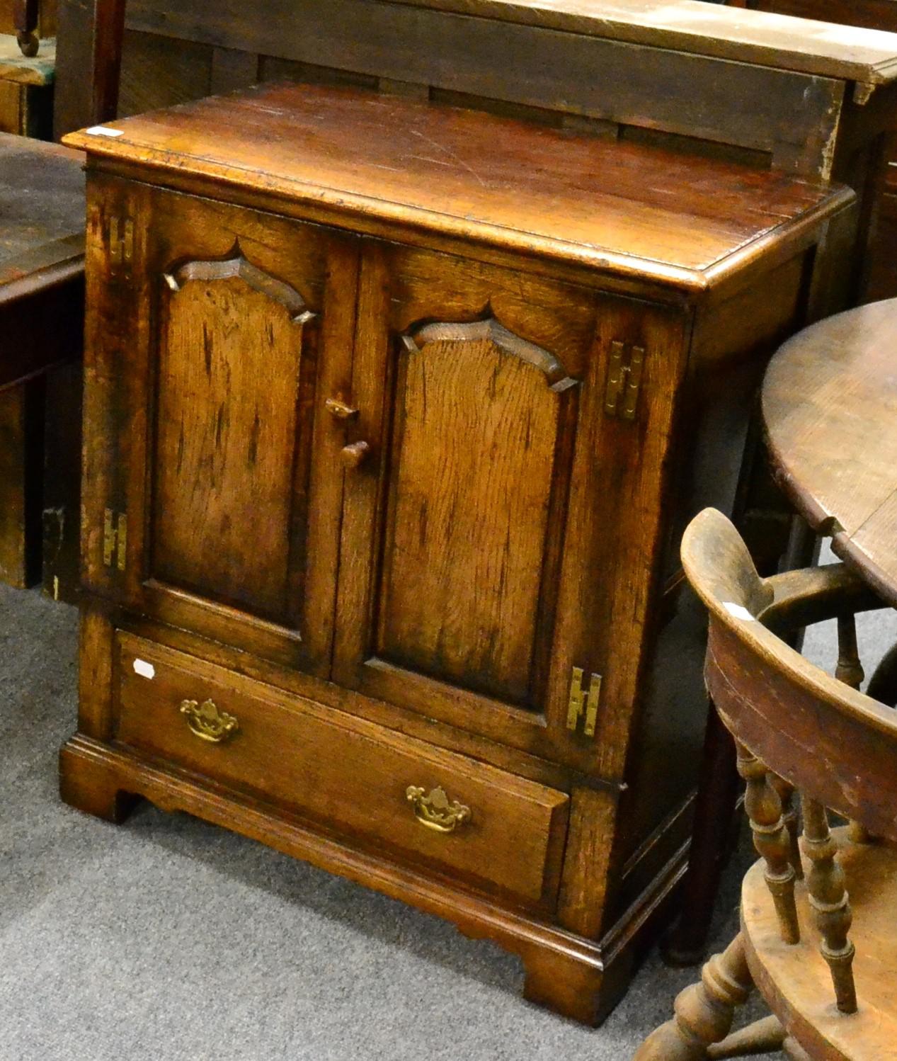 A Titchmarsh & Goodwin oak cabinet, model RL776/NC, two fielded cupboard doors with H brass