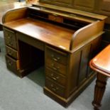 A 1920's oak roll top desk