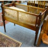 A Victorian mahogany cane sided crib