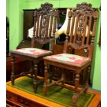 A pair of Period style carved hall chairs
