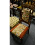 A Victorian carved oak side chair with tapestry upholstery