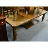 A Victorian oak extending dining table with three leaves and a winder