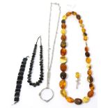 An amber necklace, a hardstone necklace and bracelet set, a lorgnette and a brooch