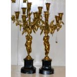 A pair of gilt metal five-light candelabra in 18th century style, with cherub supports on marble
