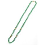 An adventurine quartz bead necklace with gold bead spacers, stamped '14k'