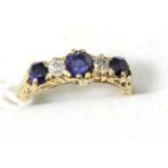 A sapphire and diamond ring, finger size N, stamped '18ct'3.4g