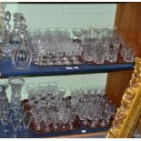 A large quantity of drinking glasses including tumblers, wines, together with decanters and vases (