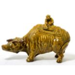 A Chinese brown glazed model of a water buffalo, a monkey astride its cover, 19th century