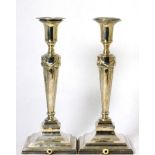 A pair of silver candlesticks, the bases drilled for electricity