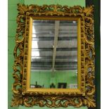 A reproduction gilt framed wall mirror