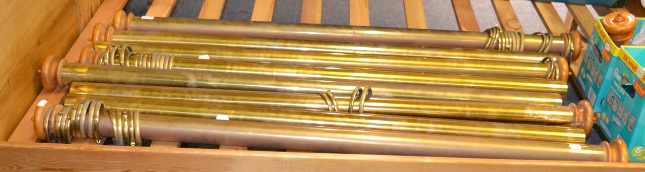 Eight brass curtain poles with rings and caps