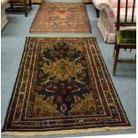 An Afghan Balouch rug, the field with a flowerhead medallion framed by spandrels and narrow borders,