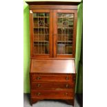 An Edwardian checkered, string inlaid mahogany, leaded and coloured glass bureau bookcase