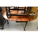 A George III mahogany drop flap table on cabriole supports with pad feet