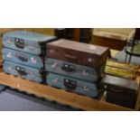 A group of eight vintage suitcases