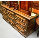 An oak sideboard Some fading to leather on outer surface. Leather hinge to frieze split. Lock recess