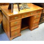 A late Victorian walnut desk, stamped James Shoolbred & Co, 123cm wide