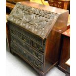 A George III and later carved oak bureau