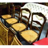 A set of four reproduction oak dining chairs