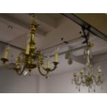 A brass five light chandelier together with a glass lustre drop five light chandelier and a six