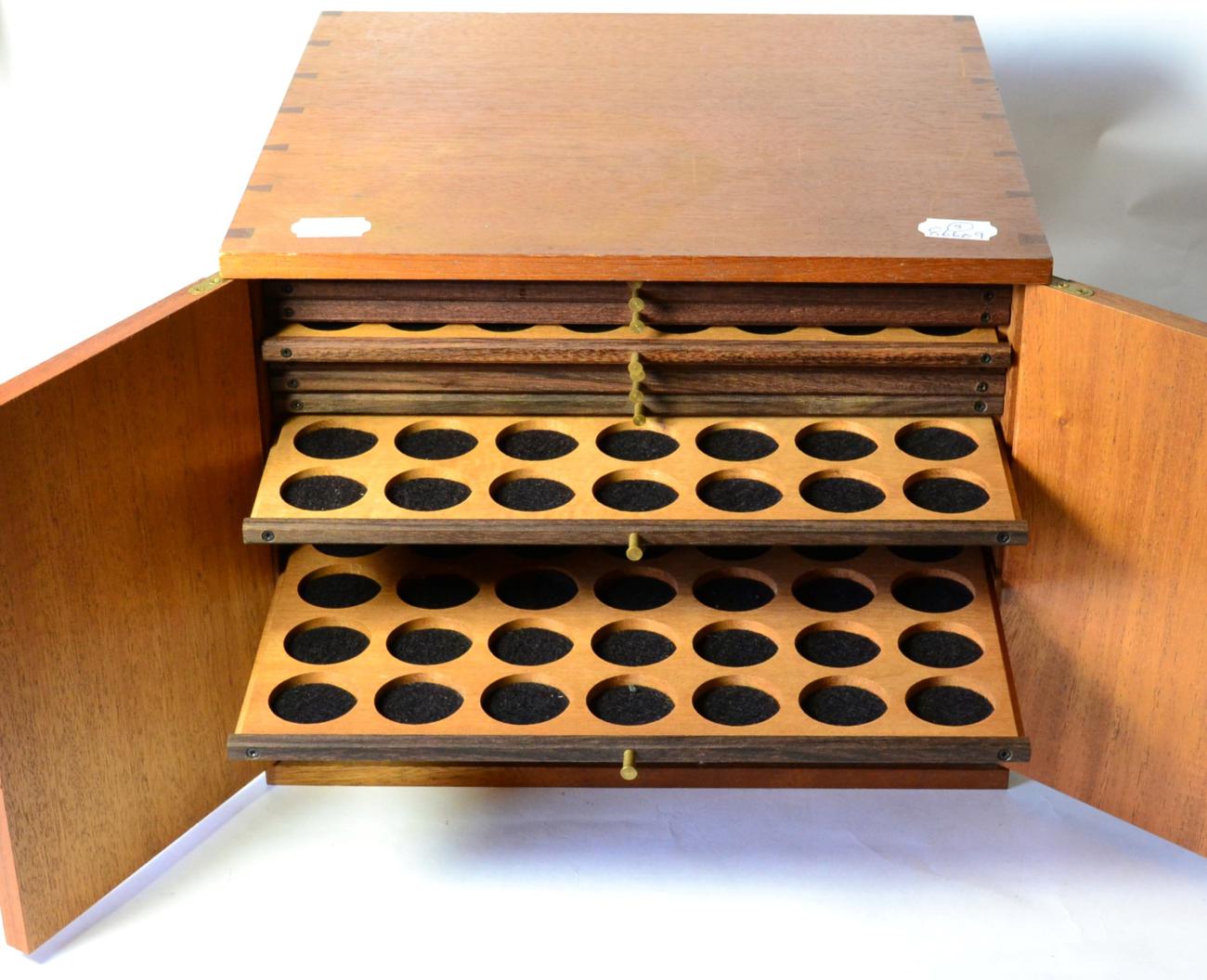 A Mahogany Coin Cabinet, 32.5cm x 30cm x 26.5cm, containing 20 trays with double-holed spaces for