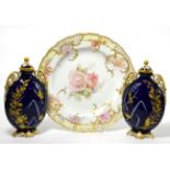 A Meissen cabinet plate painted with flowers (second) together with a pair of Worcester urns and