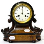 A Victorian striking mantel clock, enamel Roman dial, twin-train movement, carved dolphin supports