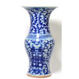 A Chinese blue and white vase 36.5cm high. Several chips to the rim.