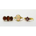 A 9ct gold garnet ring, an 18ct gold ruby and diamond cluster ring and an opal ring (a.f.)9ct gold