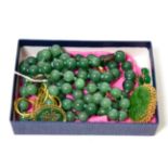 A carved jade brooch in a frame stamped '585', a pair of jade set screw back earrings, stamped '