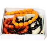 An amber bead necklace, a French black jet necklace and an orange coloured bead necklace (3)