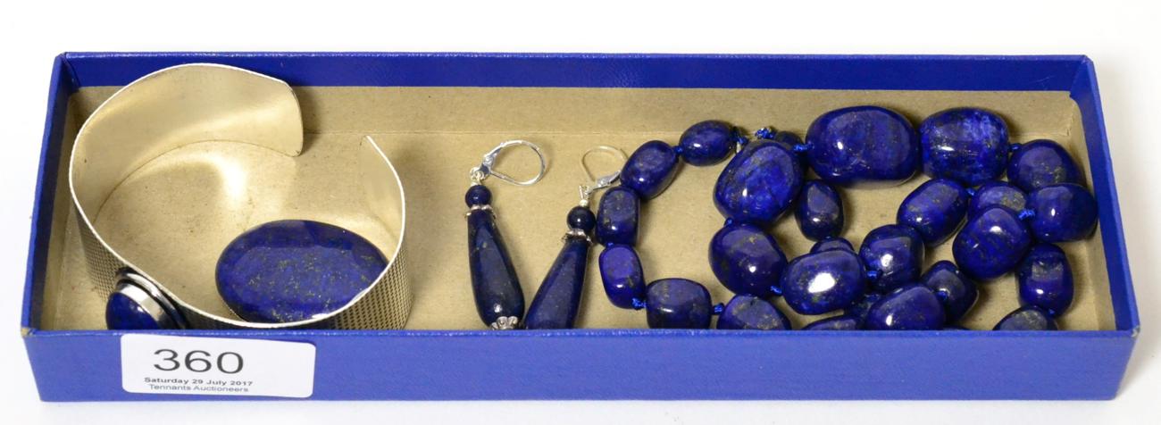 A lapis lazuli necklace, a pair of lapis lazuli drop earrings, a lapis lazuli brooch and a lapis